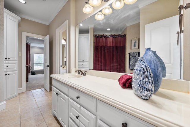 bathroom with vanity, ornamental molding, and tile patterned floors