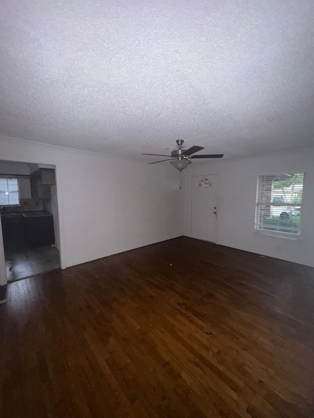 unfurnished room with dark hardwood / wood-style flooring, ceiling fan, and a textured ceiling