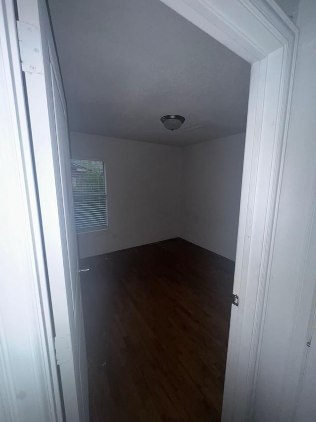 empty room featuring dark hardwood / wood-style flooring