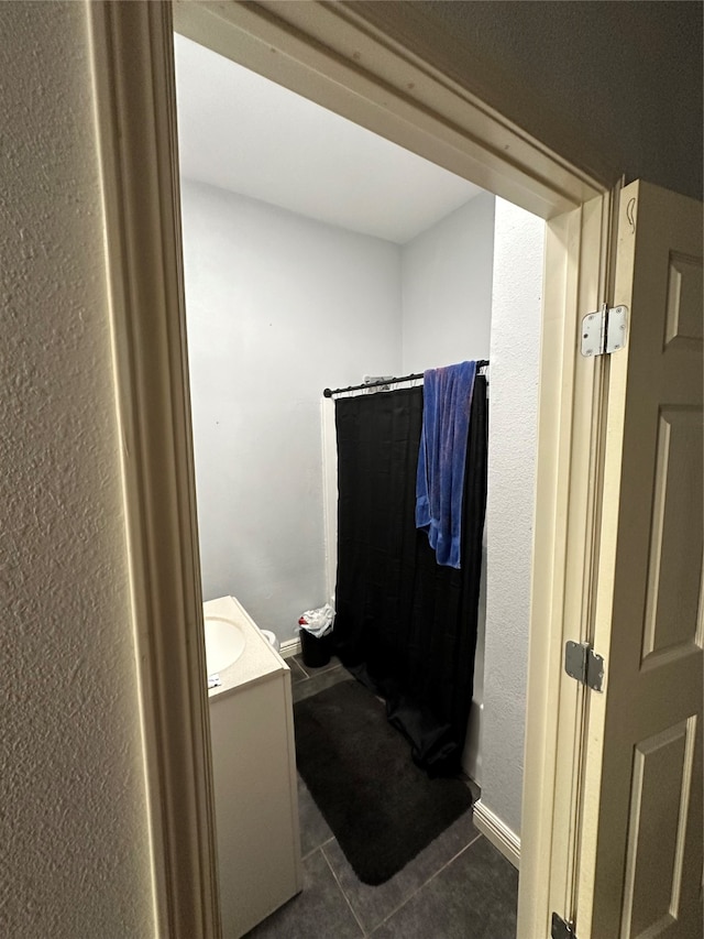 bathroom featuring vanity, tile patterned floors, and curtained shower