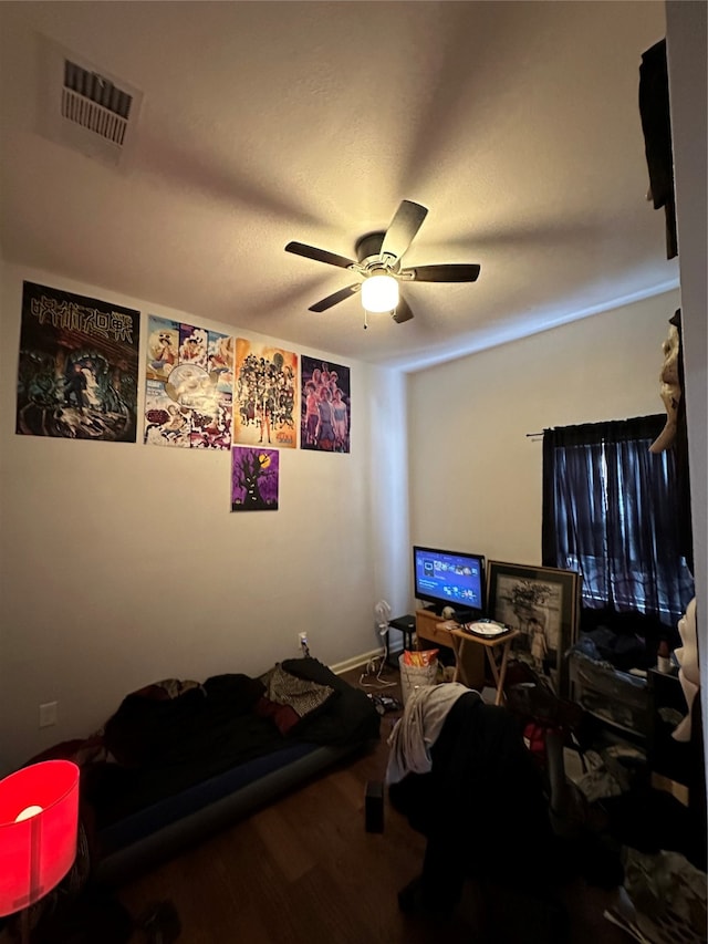 bedroom with hardwood / wood-style floors and ceiling fan