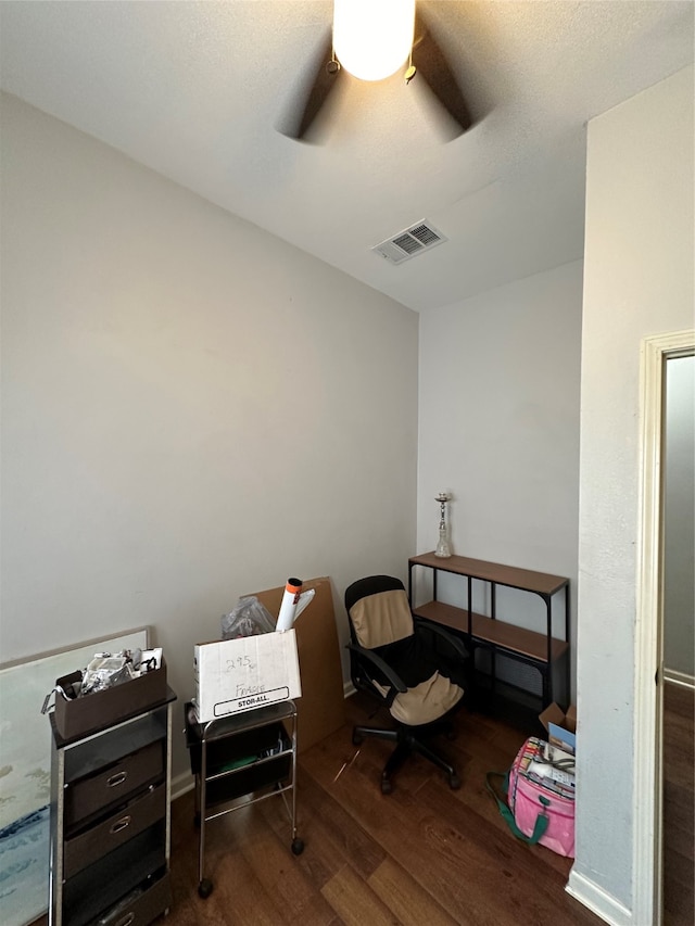 interior space featuring a textured ceiling, dark wood-type flooring, and ceiling fan