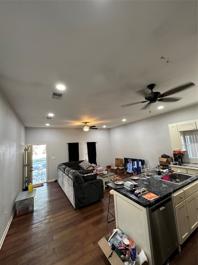 kitchen with white cabinetry, dark hardwood / wood-style flooring, sink, a breakfast bar area, and dishwasher