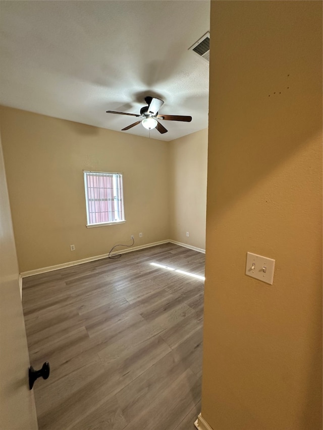 spare room featuring hardwood / wood-style floors and ceiling fan