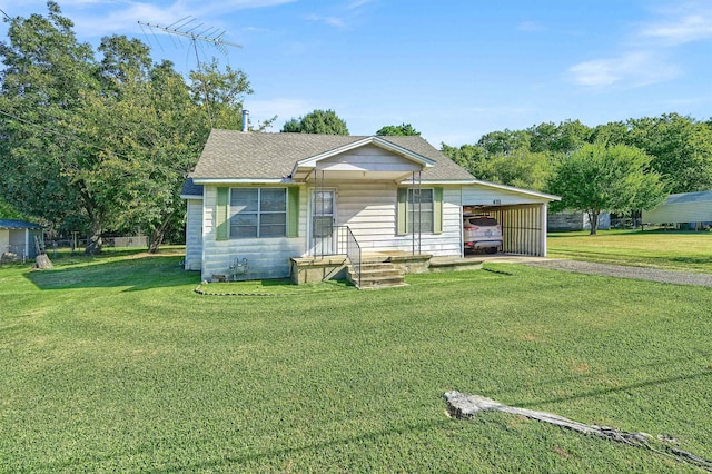 bungalow-style house featuring a carport and a front lawn