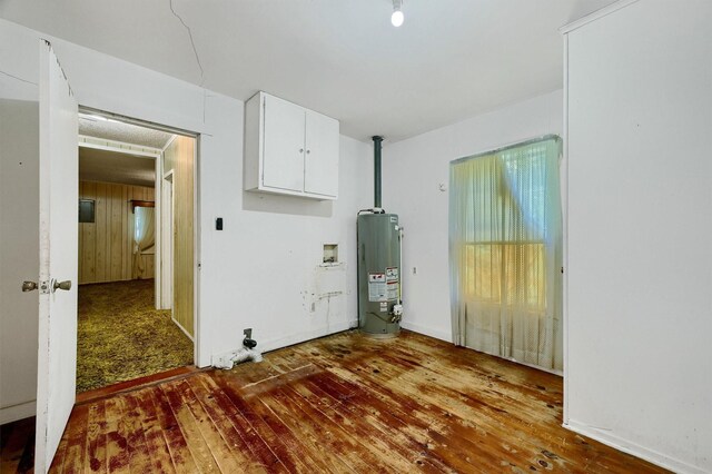 spare room with gas water heater and hardwood / wood-style flooring