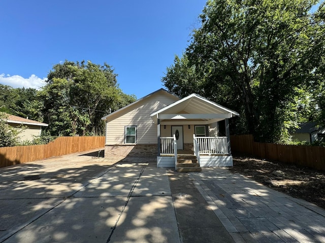 bungalow with covered porch and fence