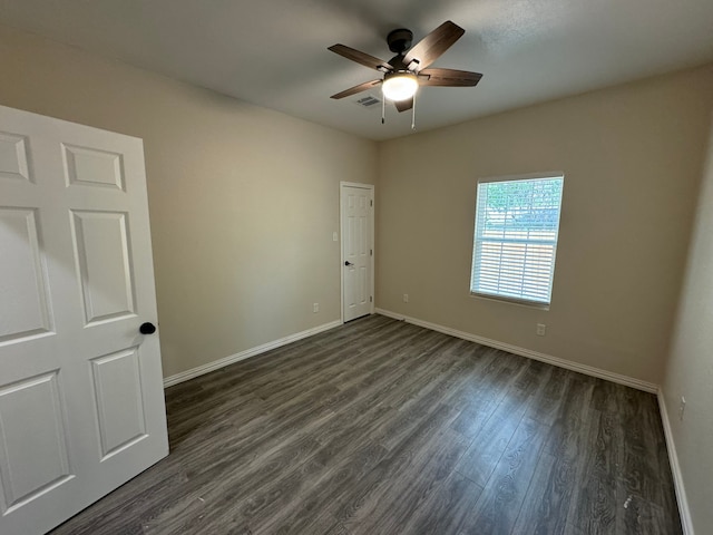 unfurnished bedroom featuring dark hardwood / wood-style floors and ceiling fan