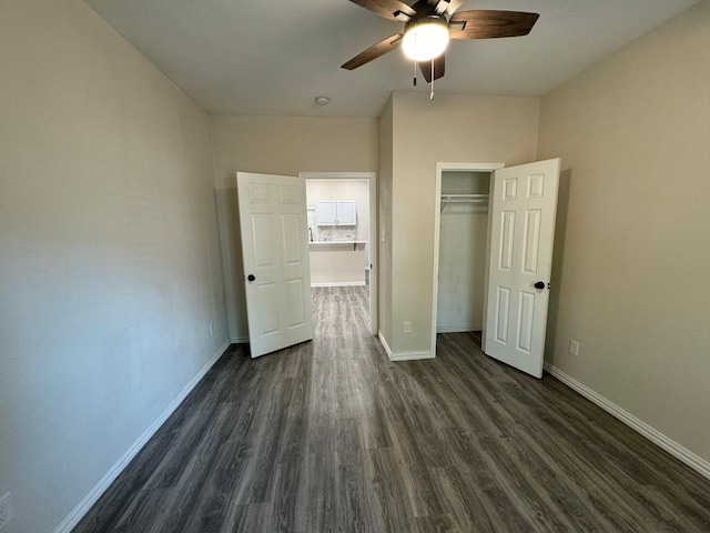 unfurnished bedroom featuring baseboards, a closet, ceiling fan, and dark wood-style flooring