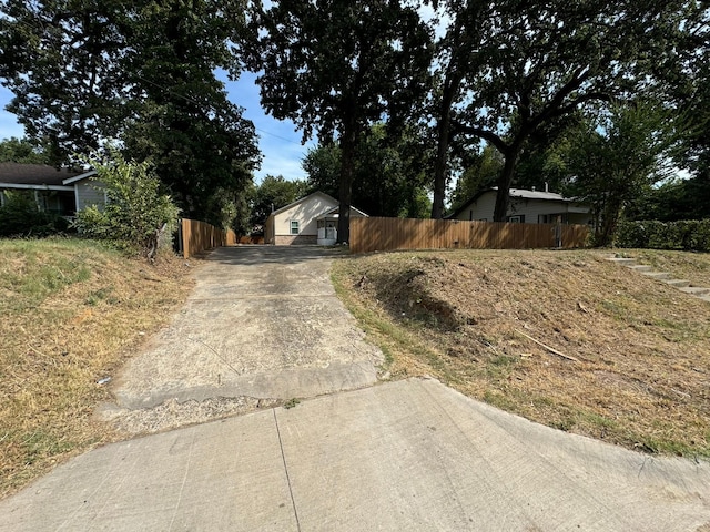 view of road featuring concrete driveway