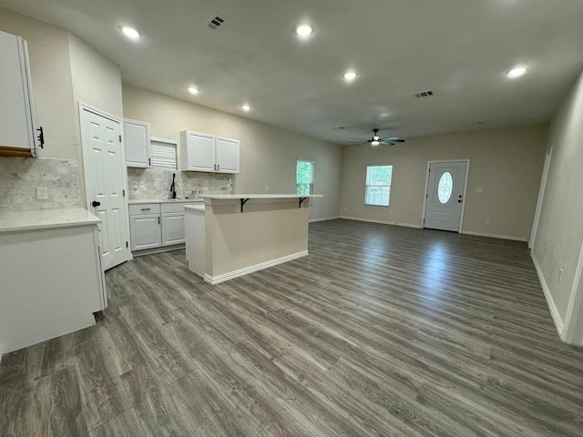 kitchen with a ceiling fan, backsplash, white cabinetry, dark wood-style floors, and recessed lighting