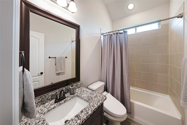 full bathroom featuring lofted ceiling, vanity, toilet, and shower / bath combo