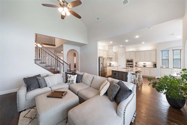 living room with high vaulted ceiling, sink, ceiling fan, and dark hardwood / wood-style floors