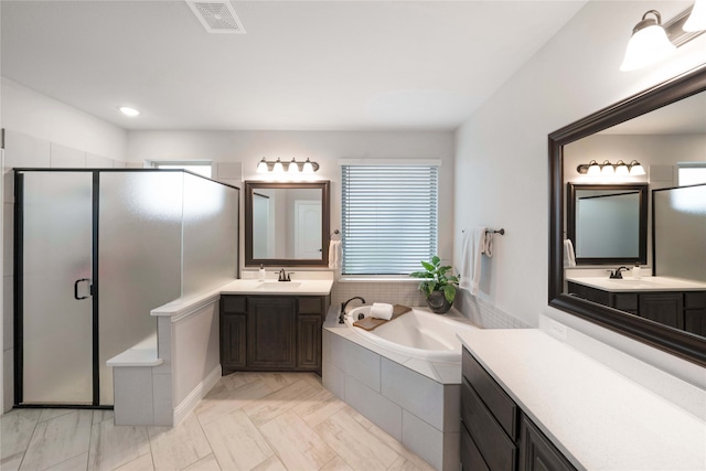 bathroom with vanity and independent shower and bath