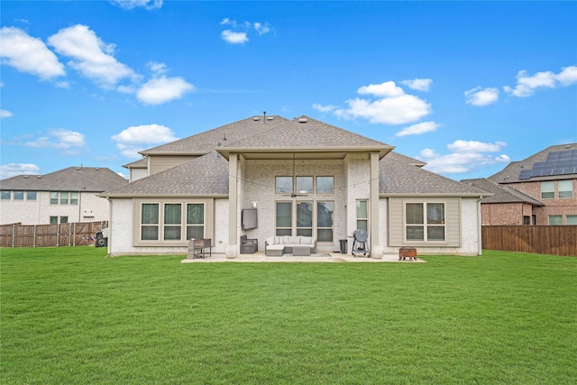 rear view of property with outdoor lounge area, a yard, and a patio area