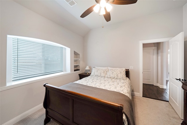 bedroom with lofted ceiling, ceiling fan, and light carpet