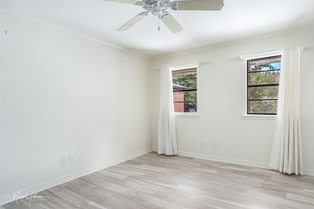 empty room with ceiling fan, crown molding, and light hardwood / wood-style floors