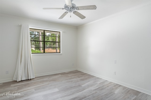 spare room featuring baseboards, a ceiling fan, light wood-style flooring, and crown molding