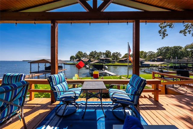 wooden terrace featuring a boat dock and a water view