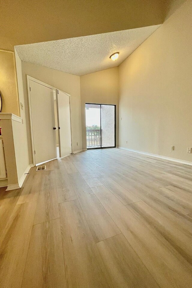 unfurnished room featuring light hardwood / wood-style floors, ceiling fan, and sink