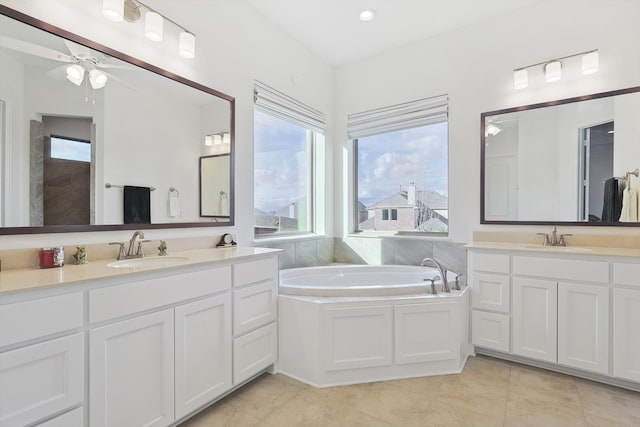 bathroom featuring tile patterned floors, ceiling fan, a bath, and vanity