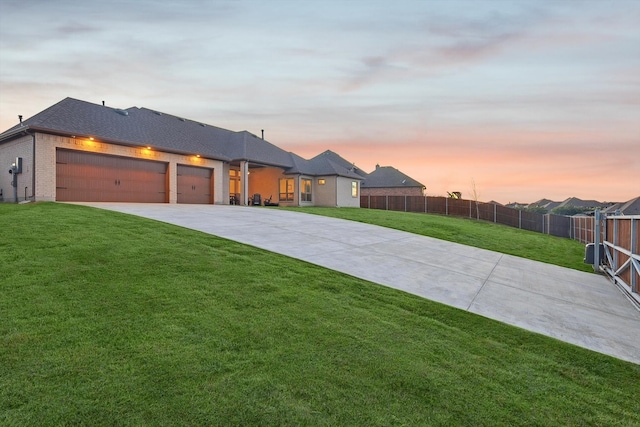 view of front of house with a lawn and a garage