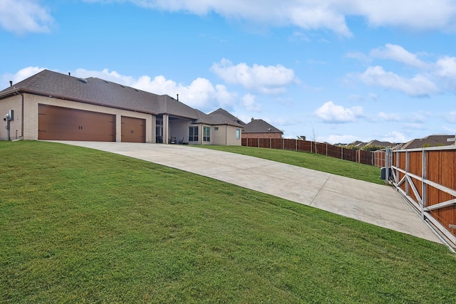 view of front of property with a front yard and a garage