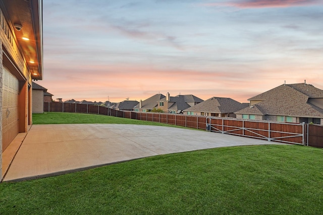 yard at dusk with a patio