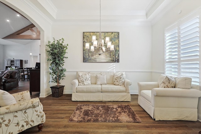 living room with a notable chandelier, dark hardwood / wood-style floors, and crown molding