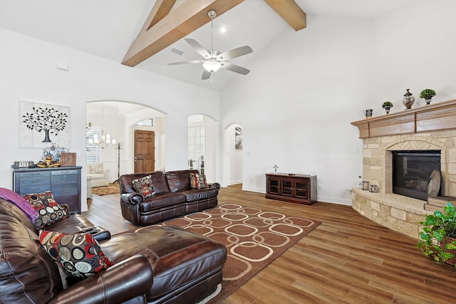 living room featuring high vaulted ceiling, beamed ceiling, ceiling fan with notable chandelier, and hardwood / wood-style floors