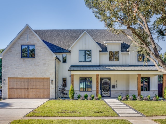 modern inspired farmhouse featuring a porch, a garage, and a front lawn