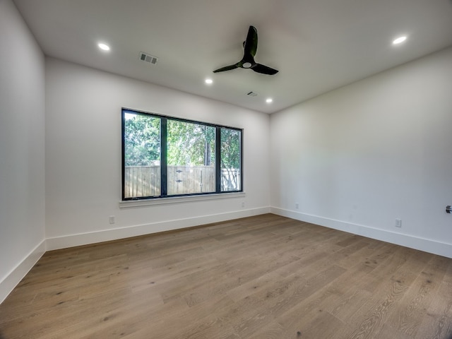 empty room with light wood-type flooring and ceiling fan