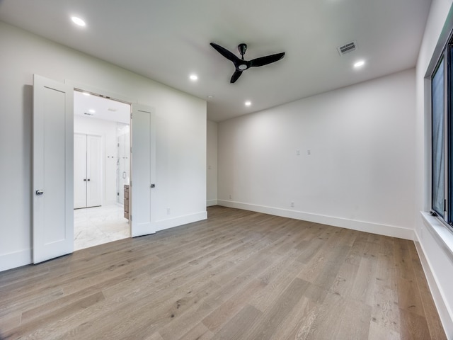 spare room featuring ceiling fan and light hardwood / wood-style floors