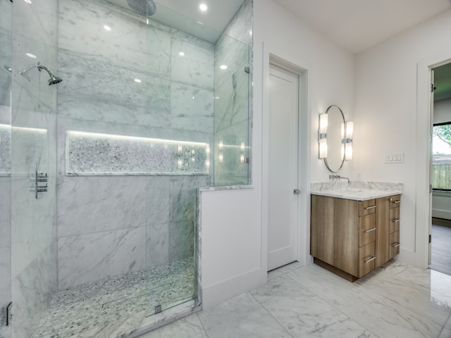 bathroom with vanity and tiled shower