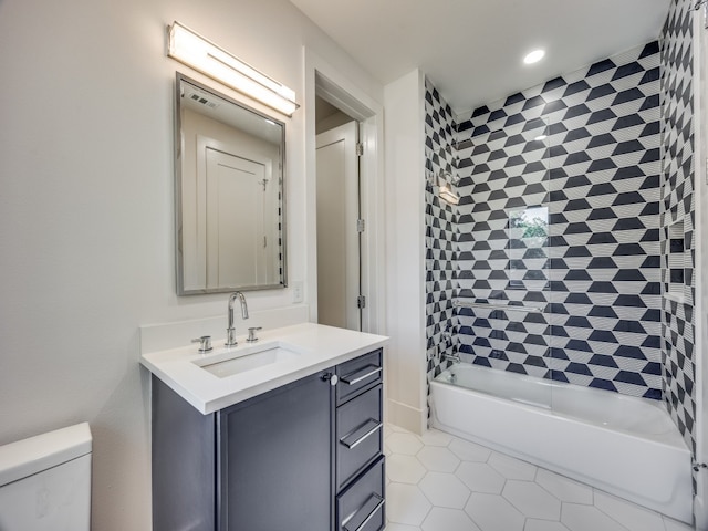 full bathroom with tile patterned floors, vanity, toilet, and tiled shower / bath