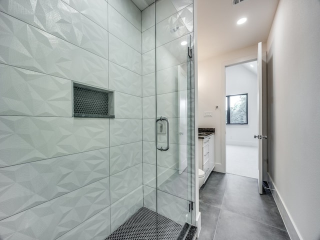 bathroom featuring vanity, toilet, and a shower with door