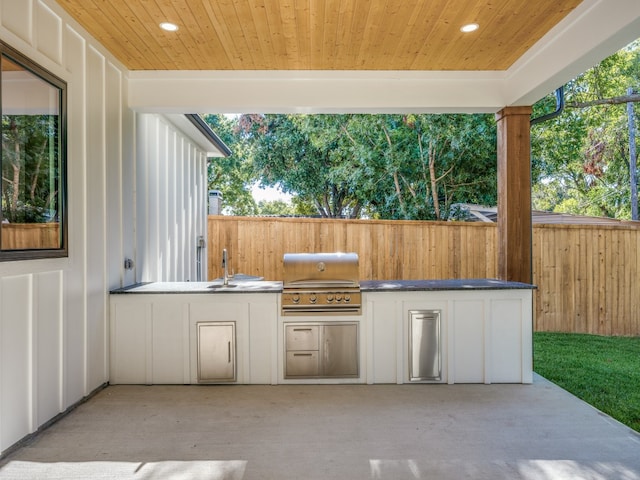 view of patio with area for grilling, sink, and grilling area