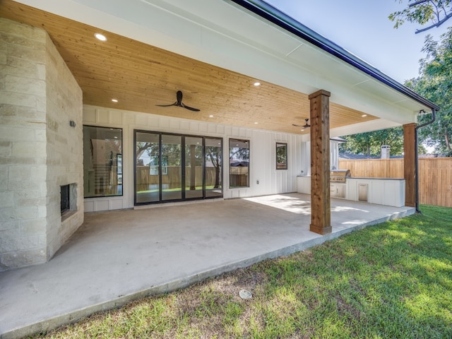 view of patio / terrace featuring ceiling fan and exterior kitchen