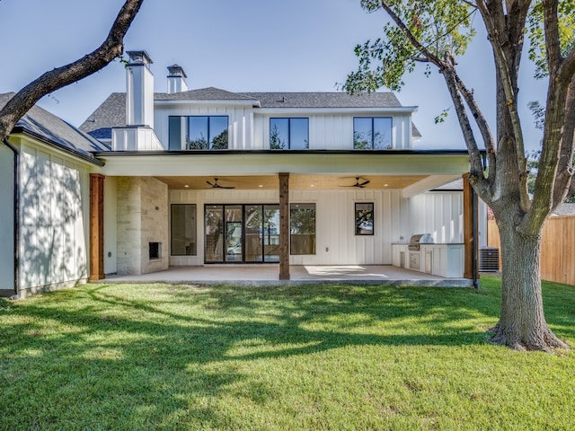 back of property featuring a yard, area for grilling, ceiling fan, and a patio area