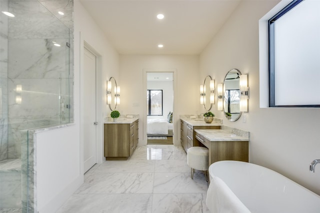 bathroom featuring vanity and independent shower and bath