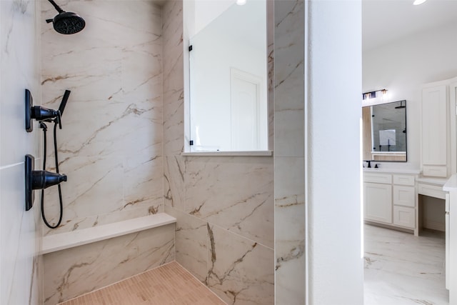 bathroom featuring vanity and tiled shower