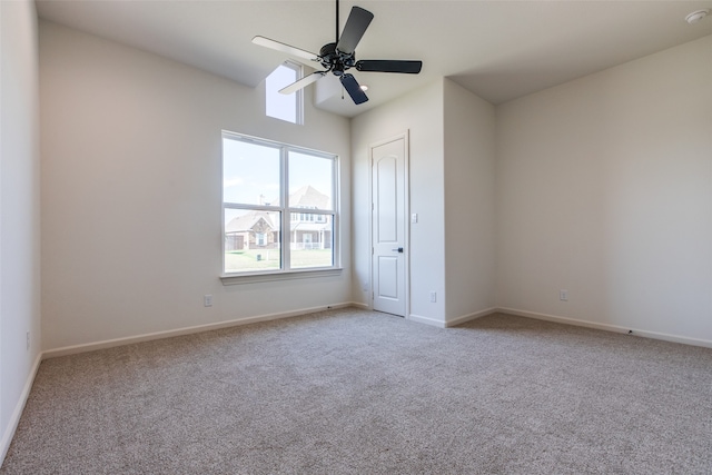 carpeted spare room with ceiling fan