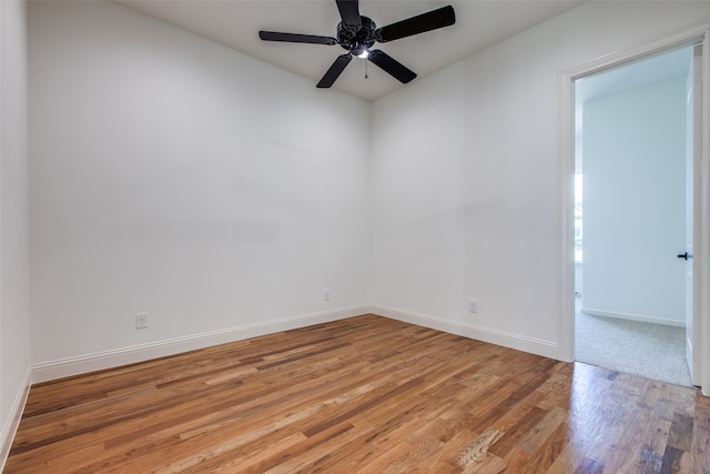 spare room featuring wood-type flooring and ceiling fan