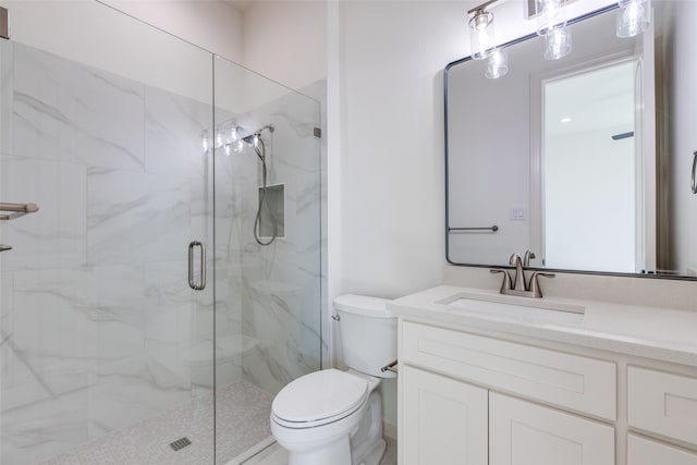 bathroom featuring vanity, toilet, and an enclosed shower