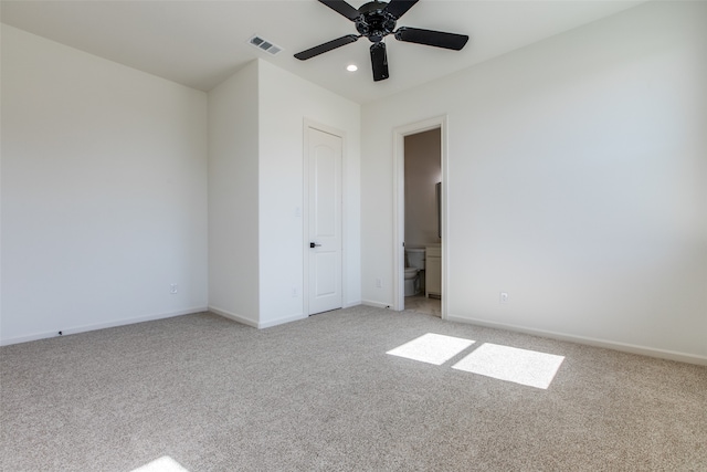 spare room with ceiling fan and light colored carpet