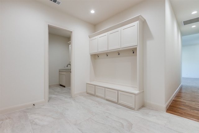 mudroom featuring light wood-type flooring and sink