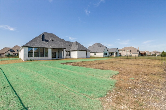 1140 Macgregor Ln, Gunter, TX 75058 - back of property with a shingled roof and brick siding