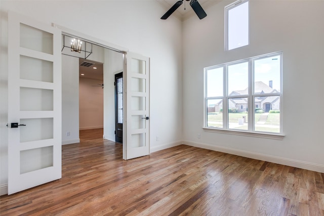 1140 Macgregor Ln, Gunter, TX 75058 - unfurnished bedroom with a high ceiling, wood finished floors, french doors, baseboards, and ornamental molding