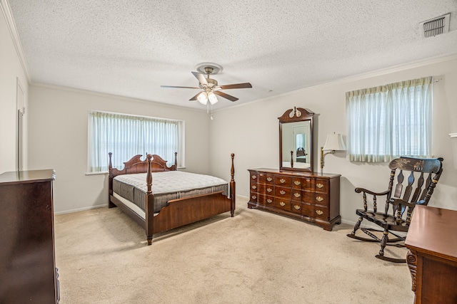 bedroom featuring a textured ceiling, carpet, ceiling fan, and ornamental molding