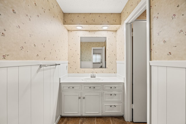 bathroom with a textured ceiling and vanity